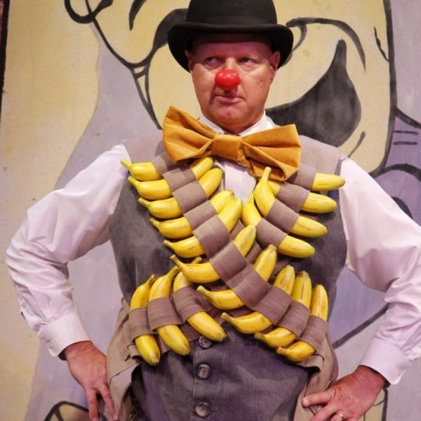 Picture of a clown with bananas on his chest
